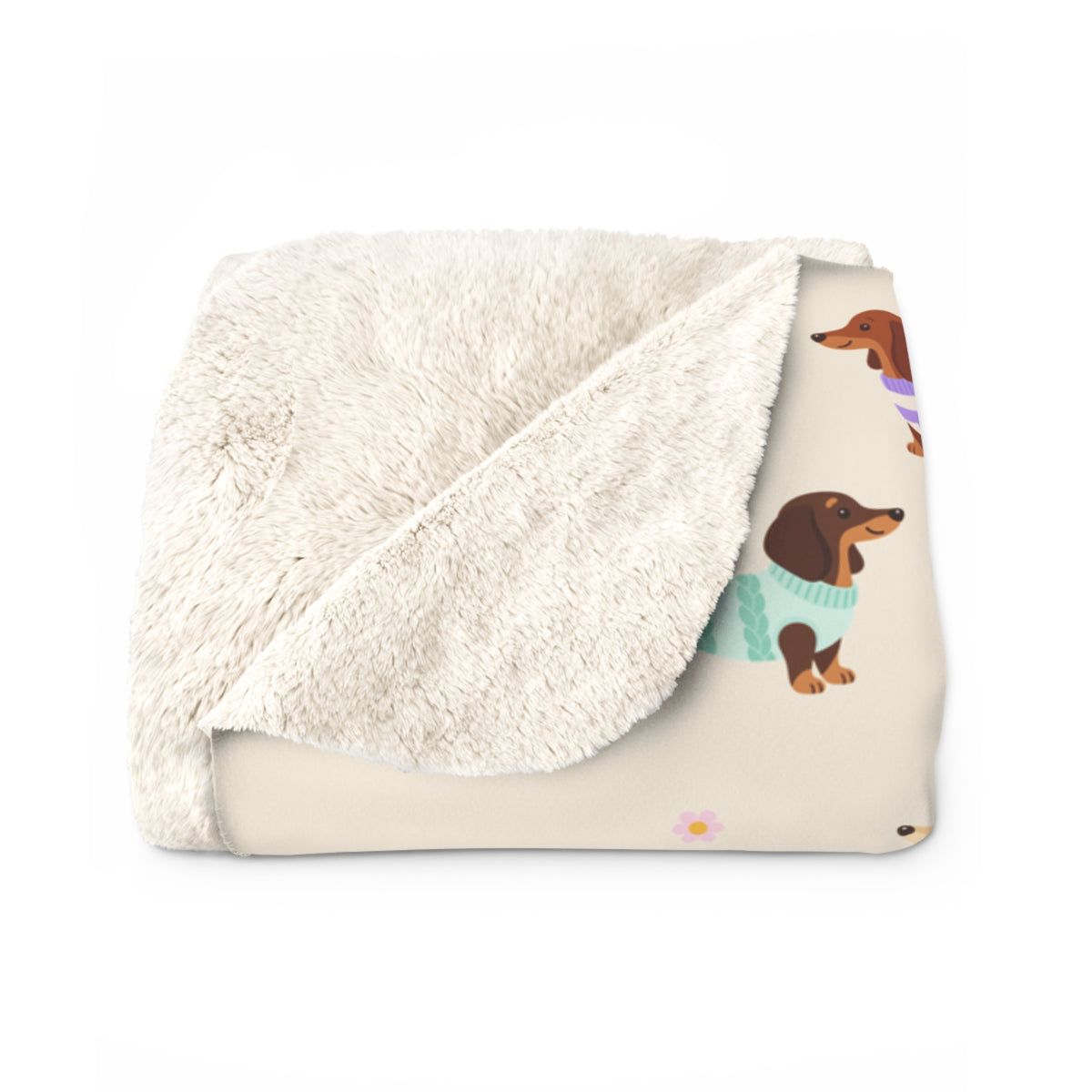Fluffy sherpa back at a folded corner of the Cream sherpa fleece blanket, beside its printed dachshund front.