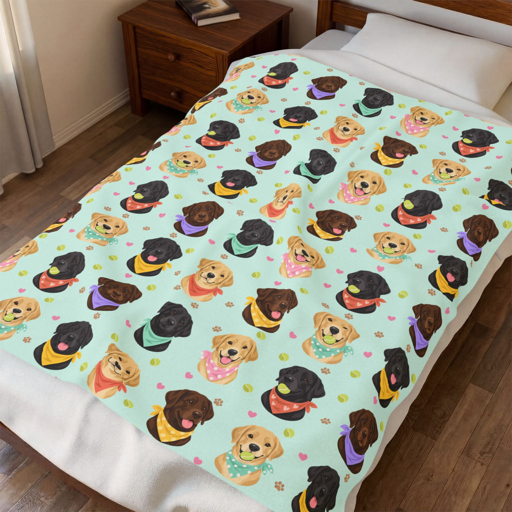 Mint velveteen plush Lab blanket covers a made bed beside a wooden nightstand, with the portraits spread across its pale mint ground.