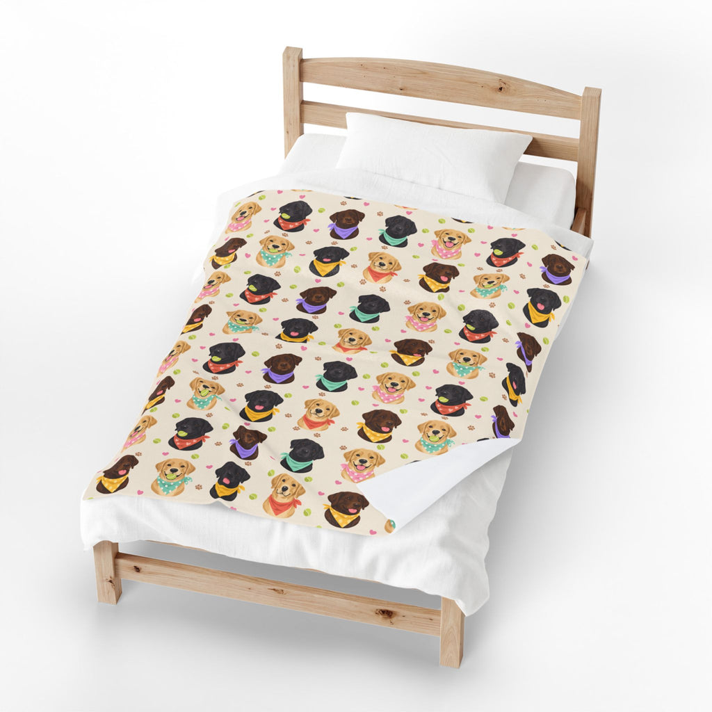 One corner of the Cream velveteen plush Lab blanket folds back on a light wood bed, revealing the plain white backing.