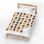 One corner of the Cream velveteen plush Lab blanket folds back on a light wood bed, revealing the plain white backing.