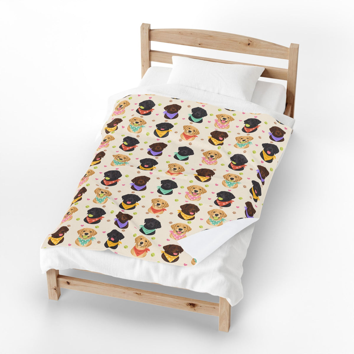 One corner of the Cream velveteen plush Lab blanket folds back on a light wood bed, revealing the plain white backing.