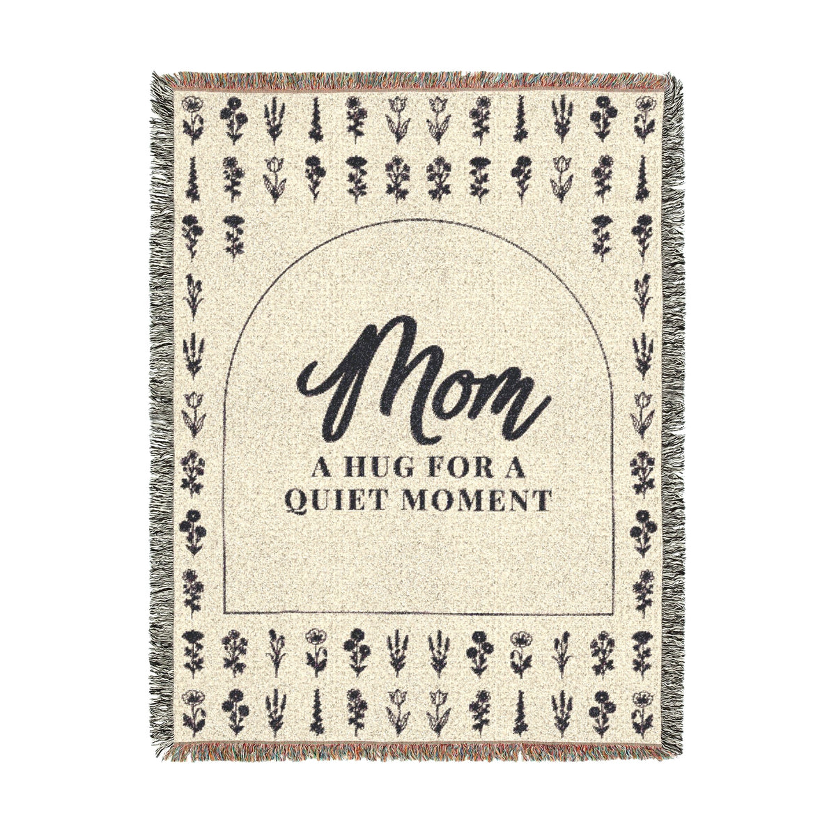 A tall Cream wildflower throw in woven cotton, 60 x 80 inches, lies on white with "Mom" inside a dark arch, even flower rows and fringe.