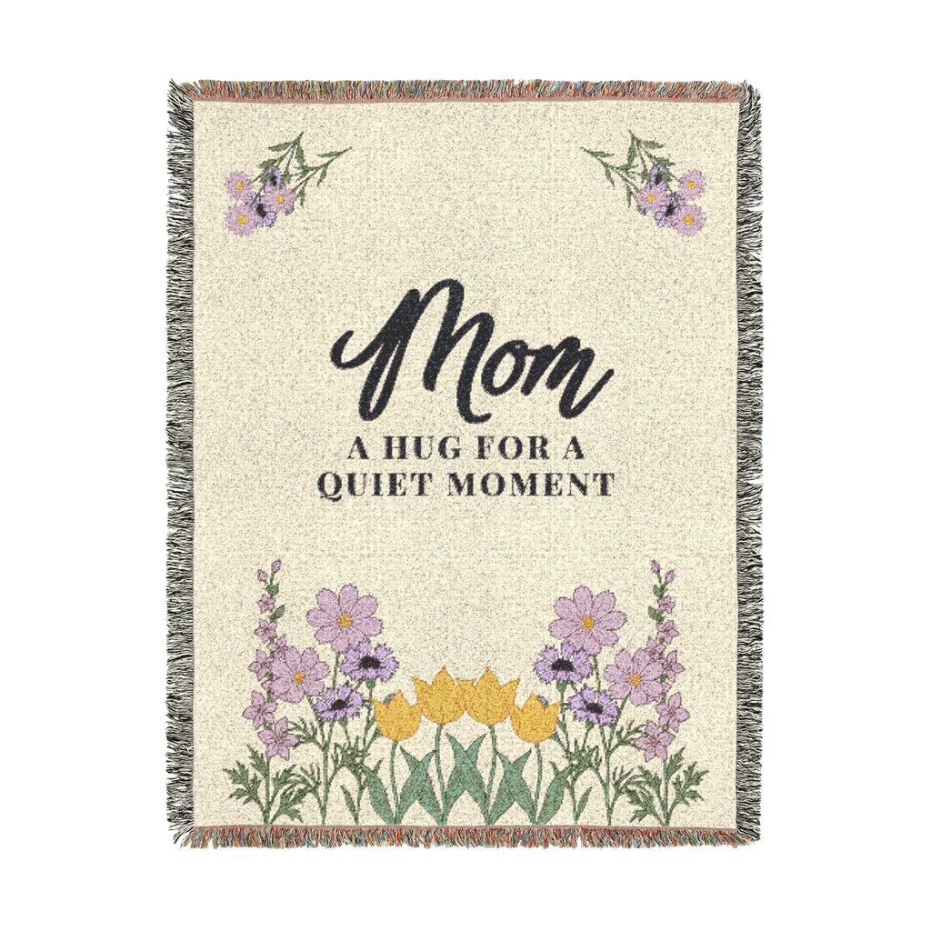 The 60 x 80 inch Cream woven cotton blanket is shown tall on white, with dark words, soft lilac wildflowers and fringe on all four edges.