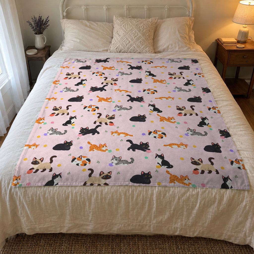 Morning light falls on a 50 x 60 inch Blush cat print blanket in velveteen plush on a guest room bed with a white iron frame.