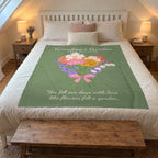 A 50 x 60 inch Sage Grandma's Garden blanket in velveteen plush lies on a white queen bed in an attic bedroom with sloped ceilings.