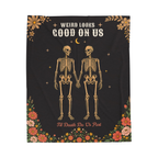 The Black gothic blanket in velveteen plush lies flat on white, with two skeletons below "WEIRD LOOKS / GOOD ON US".