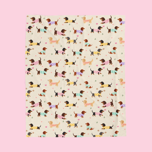 Full pattern on a Cream velveteen plush blanket on a blush backdrop with dachshunds in knit sweaters.