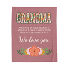Laid flat on white, a Dusty rose blanket for grandma in velveteen plush shows floral "GRANDMA" above "THIS HUG IS FROM US ALL."