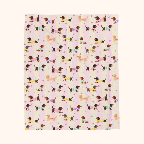 Wide soft cream and blush bands on the Pink stripes velveteen plush blanket, with sweater dogs, laid flat on cream.