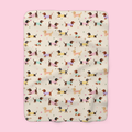 Sweater-wearing dachshunds cover a Cream sherpa fleece blanket laid flat on a soft blush backdrop.