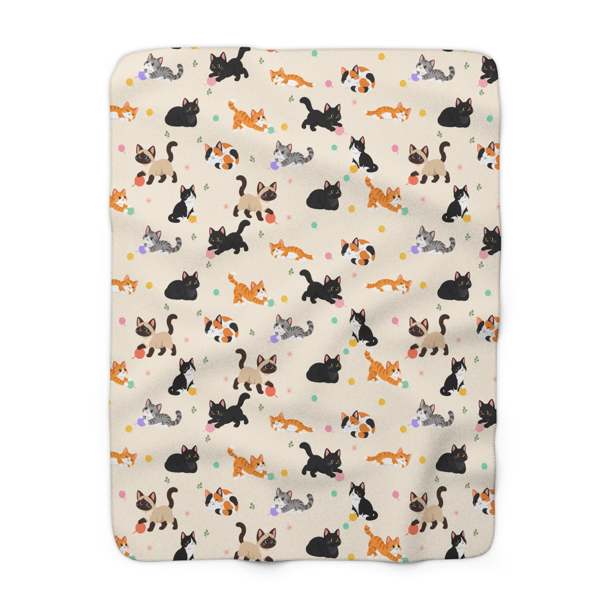 Cream cat sherpa blanket laid flat on white, showing cartoon cats, pastel yarn balls and daisies on the printed fleece front.