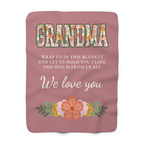 Laid flat on white, a Dusty rose grandma hug blanket in sherpa fleece shows floral letters and "THIS HUG IS FROM US ALL."