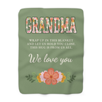 Sage grandma hug blanket in sherpa fleece lies flat on white, showing floral "GRANDMA" above the cream family message.