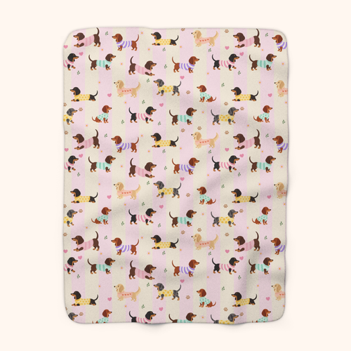 Blanket with dachshund artwork in sherpa fleece, Pink stripes color, showing the full pattern on cream.