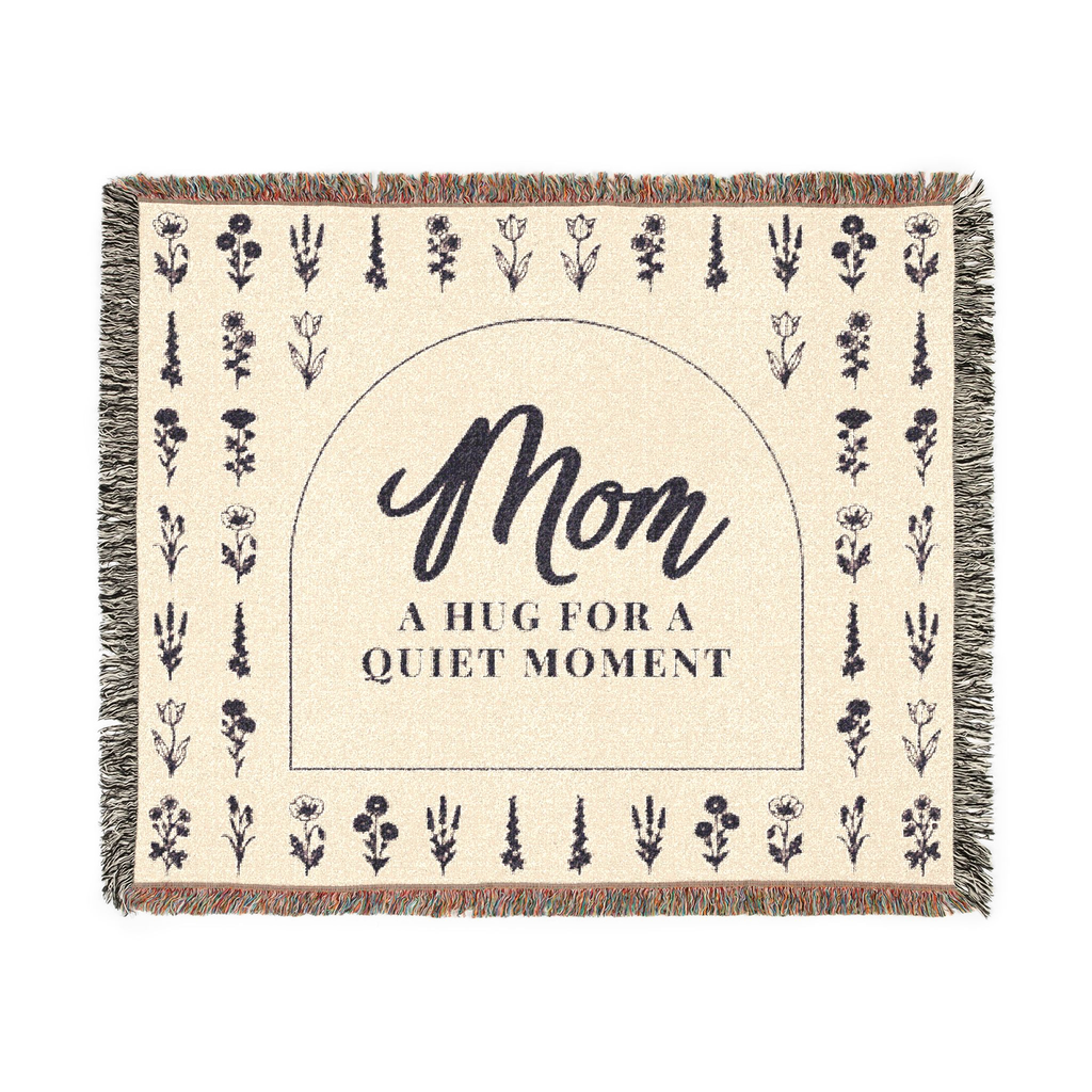 Cream wildflower throw blanket in woven cotton, 60 x 50 inches, lies flat on white with a dark arch, flower rows and fringe on all edges.