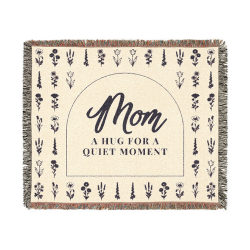 Cream wildflower throw blanket in woven cotton, 60 x 50 inches, lies flat on white with a dark arch, flower rows and fringe on all edges.