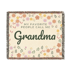 Cream floral throw blanket in woven cotton lies flat on white, with "MY FAVORITE PEOPLE CALL ME Grandma", little flowers and leaves, and fringe on all sides.