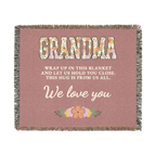 Laid flat on white, a Dusty rose grandma throw blanket in woven cotton shows floral "GRANDMA", cream script and fringe on all four sides.