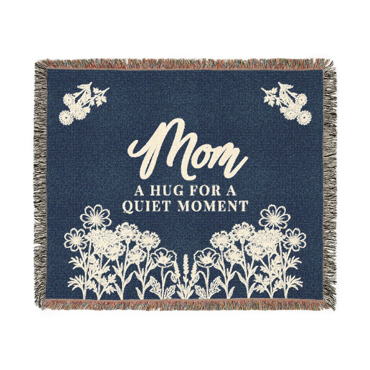 A Navy mom throw blanket in woven cotton lies flat on white, measuring 60 x 50 inches with cream words and flowers and fringe on all edges.
