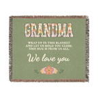Sage grandma throw blanket in woven cotton lies flat on white, with floral "GRANDMA" capitals, cream words and fringe on all four sides.