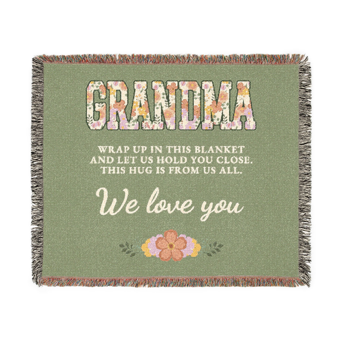 Sage grandma throw blanket in woven cotton lies flat on white, with floral "GRANDMA" capitals, cream words and fringe on all four sides.