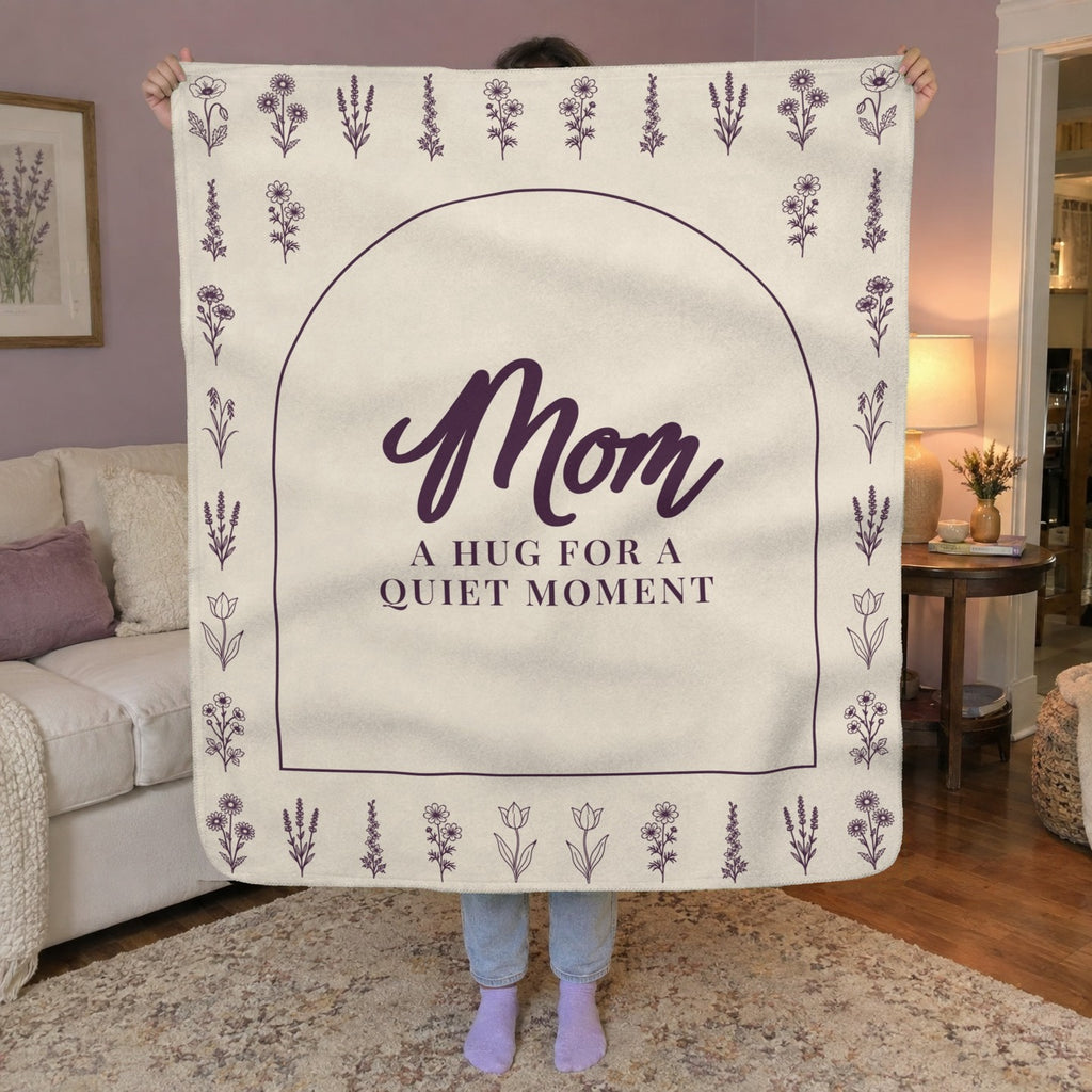 A woman holds up a 50 x 60 inch Cream sherpa fleece blanket with an arch and flower rows in a living room with soft lilac walls.